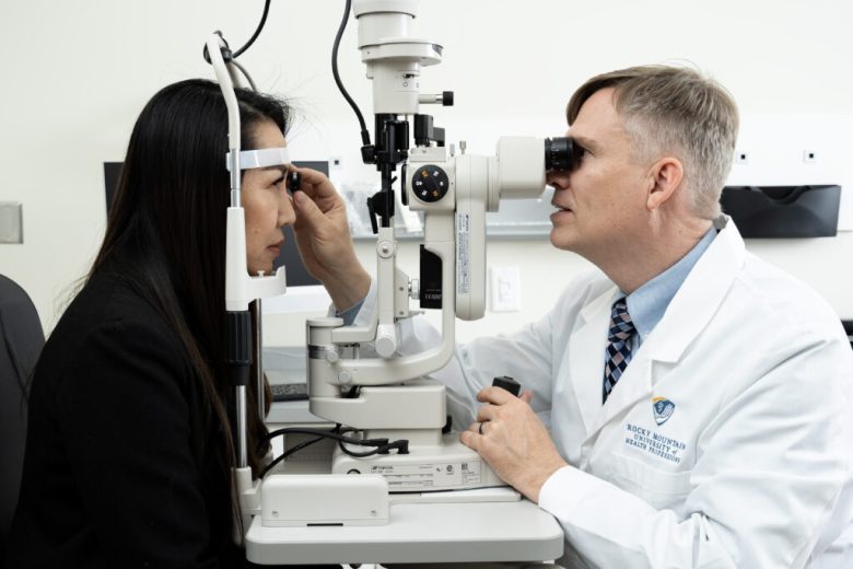 Dr. Adam Hickenbotham, right, performs an eye exam.