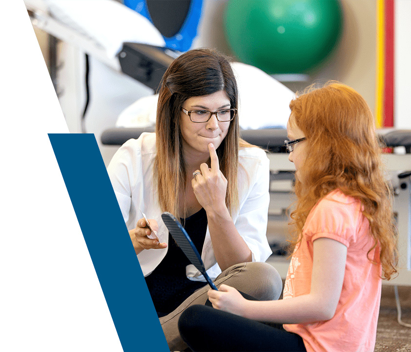 Speech-language pathology student working with child in clinic
