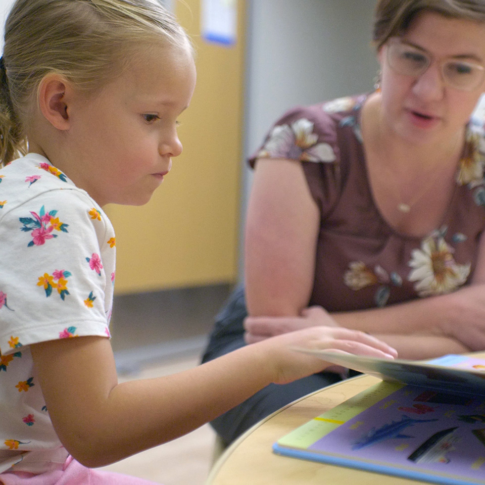 A child practicing her reading skills.