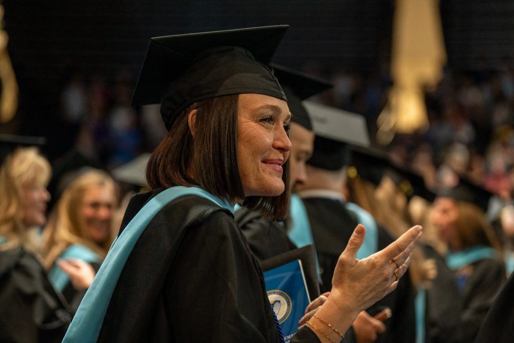 Woman claps at graduation