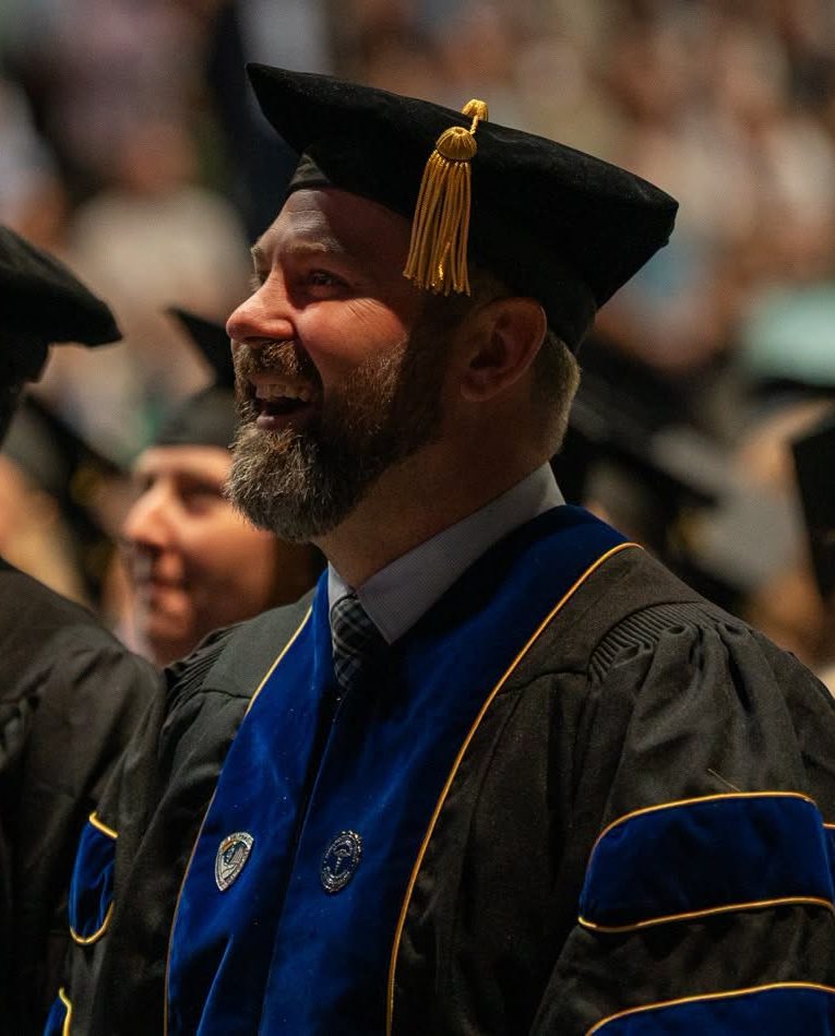 Man smiles at graduation