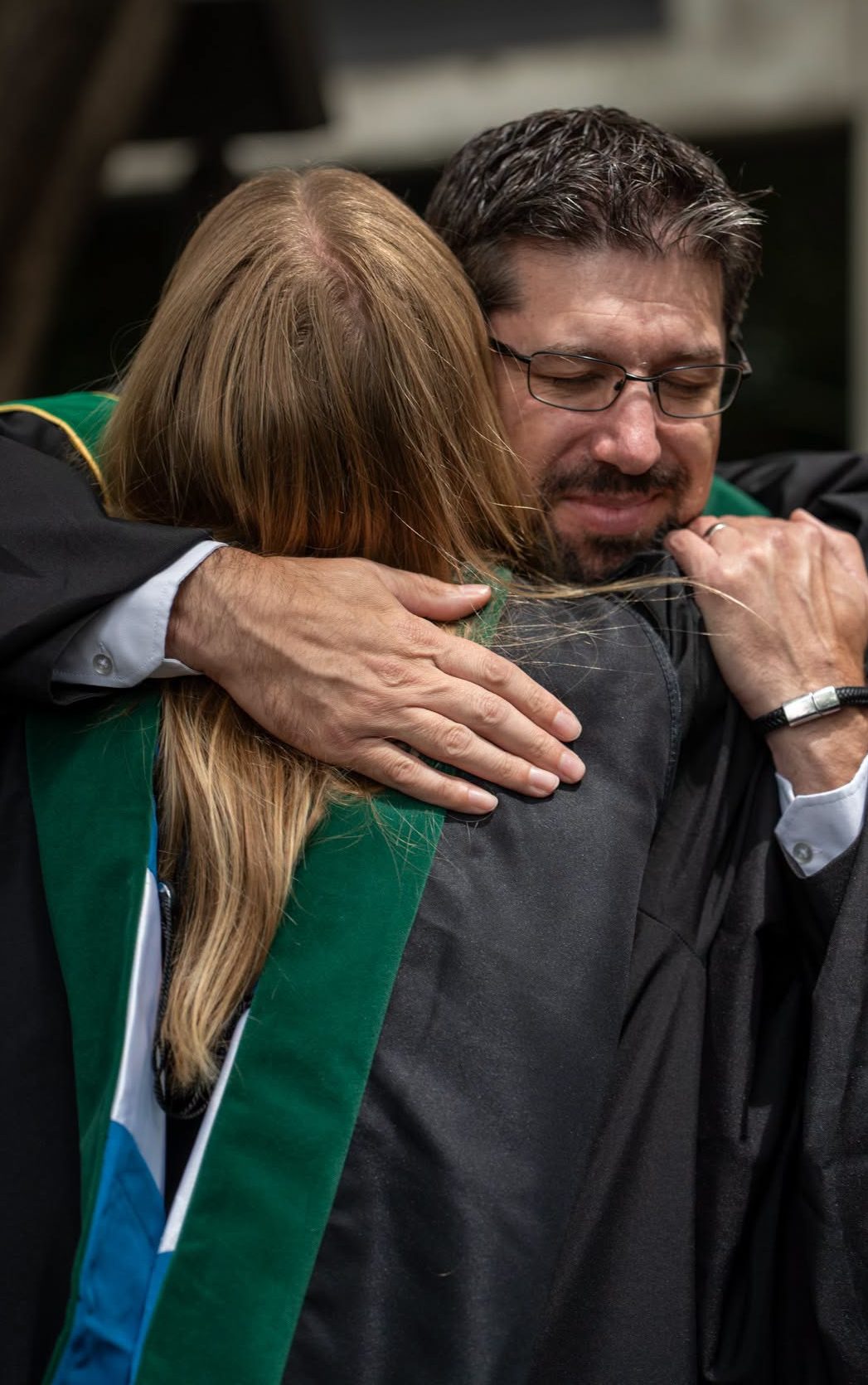Man hugs a graduate