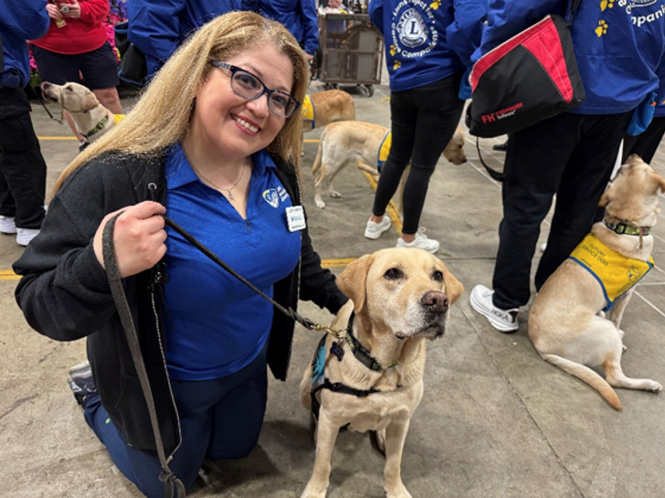 A woman poses with a dog